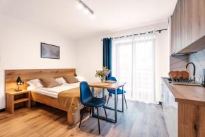 Una cama o camas en una habitación de Apartamenty Pod Wyciągiem