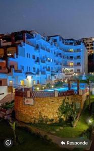 a blue building with a pool in front of it at Perle de oued laou in Oued Laou