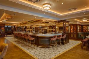 a bar in a hotel lobby with stools at The Mercantile Hotel in Dublin +30 photos