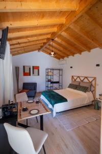 a bedroom with a large bed and a table at Magnolias Cottage with Jacuzzi and mountain view in Lousã