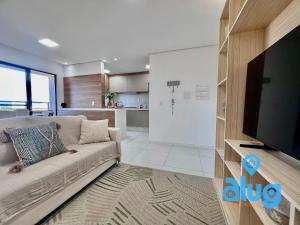 a living room with a couch and a flat screen tv at S806T1 Vista Incrível + Beto Carrero e Praia! in Penha