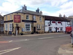 a building on the side of a street at Railway Studio Apartment in Haydon Bridge