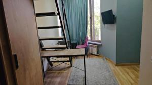 a room with a desk with a chair and a mirror at 777tsrj in Muruntau