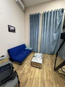 a living room with a blue couch and a table at 777tsrj in Muruntau
