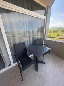 a table and chairs on a balcony with a view at STUDIO 46 South Pearl Homes in Sozopol
