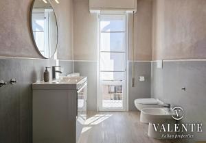 a bathroom with a toilet and a sink and a mirror at Central panoramic apartment in Montecatini Terme +33 photos