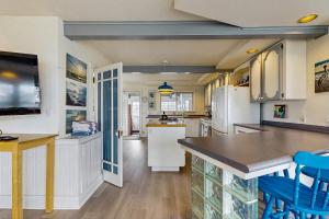 a kitchen with white appliances and blue stools at Far View in Lincoln City