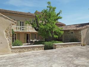 a house with a tree in front of it at Oppède Villa with Private Pool in Oppède