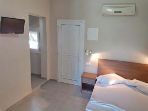 Postel nebo postele na pokoji v ubytování Kalouda Rooms