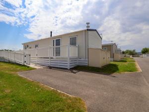 a mobile home is parked in a parking lot at Lawi39 in Abergele