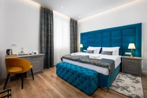 a bed with a blue headboard in a room at Boutique Hotel Golden Key - Poreč - Bed & Breakfast in Poreč +173 photos