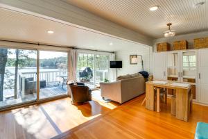 a living room with a couch and a table at Paddle and Bike Cottage with Dock in Pequot Lakes! in Pequot Lakes