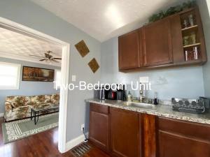 a kitchen with a sink and a couch in a room at Derby City Getaway in Louisville