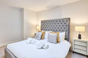 a bedroom with a large white bed with towels on it at Host & Stay - Albert House in Weymouth +19 photos