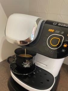 a coffee maker is making a cup of coffee at Wooden Dream with Terrace in Siedlce