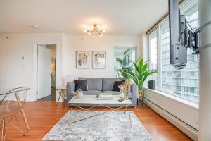 a living room with a couch and a table at Executive Unit with Spectacular Views in Vancouver
