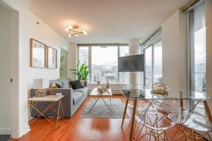 a living room with a couch and a glass table at Executive Unit with Spectacular Views in Vancouver
