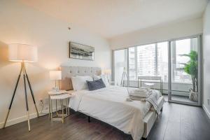 a bedroom with a large bed and a large window at Executive Unit with Spectacular Views in Vancouver +14 photos