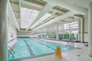 a large indoor swimming pool with a large ceiling at Executive Unit with Spectacular Views in Vancouver