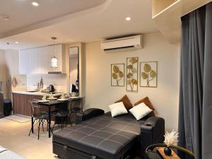 a living room with a couch and a kitchen at Tambuli Blue Premium Seaview in Lapu Lapu City