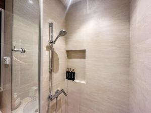 a shower with a glass door in a bathroom at Tambuli Blue Premium Seaview in Lapu Lapu City +36 photos