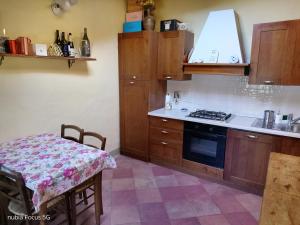 a kitchen with a table and a stove top oven at Podere Casone in SantʼAdriano
