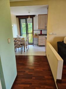 a kitchen and dining room with a table and chairs at El pisito de iker in Mondariz