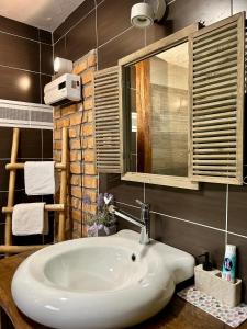a bathroom with a white sink and a mirror at Stara hiža pod Okićem in Jastrebarsko +18 photos