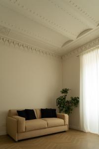 ein Wohnzimmer mit einer Couch und einem Fenster in der Unterkunft Gv Suite Collection - San Pietro Dome in Rom