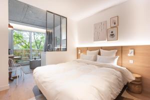Postel nebo postele na pokoji v ubytování Babel Community Hôtel Lille - Villeneuve d'Ascq