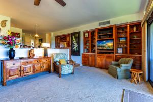 a living room with a desk and a chair at Kaanapali Royal N202 by Coldwell Banker Island Vacations in Lahaina