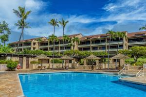 a hotel with a swimming pool in front of a building at Kaanapali Royal N202 by Coldwell Banker Island Vacations in Lahaina