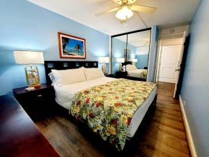 a bedroom with a bed and a large mirror at Kahana Reef 120 by Coldwell Banker Island Vacations in Kahana +47 photos
