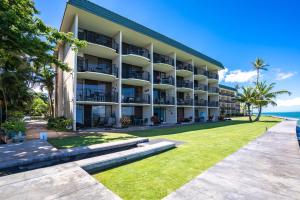 an exterior view of a building with a lawn at Kahana Reef 120 by Coldwell Banker Island Vacations in Kahana