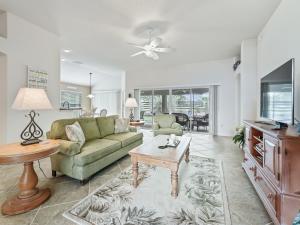 a living room with a couch and a tv at 2500 Z3A VILLAGE OF TAMARIND GROVE by REMAX Premier in The Villages