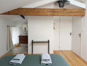 a bedroom with a bed with two towels on it at Chambre Irondas in Saint-Pierre-dʼAurillac