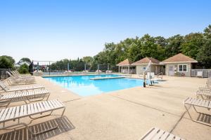 a swimming pool with lounge chairs in a resort at Savannahs Landing --- 10 Mary Elizabeth Dr in Ocean View