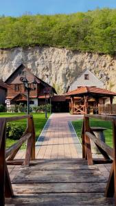 a wooden bridge leading to a building on a mountain at Stara hiža pod Okićem in Jastrebarsko +18 photos