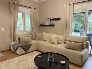 a living room with a couch and a table at Guest house Elina in Kalívia Thorikoú