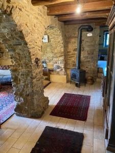 a room with a stove in a stone building at Momo 1741 - 4BR Historic stone house in the Apennines in San Martino +135 photos