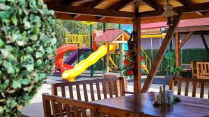 a playground with a table and a slide at Hotel Alikante in Sarnitsa
