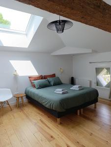 a bedroom with a bed in a room with a window at Maison Irondas in Saint-Pierre-dʼAurillac