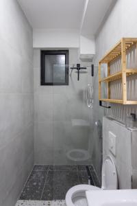 a white bathroom with a toilet and a shower at Brand new apartment close to the beach Ap 3 in Sarandë