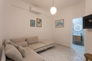 a living room with a couch and a window at Brand new apartment close to the beach Ap 3 in Sarandë