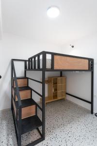 a black bunk bed with a ladder in a room at Brand new apartment close to the beach Ap 3 in Sarandë