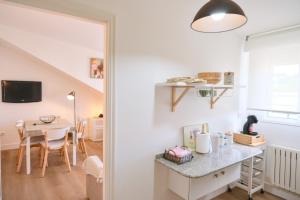 a small kitchen and dining room with a table and a dining room at Apartamento Sear Areas in Sanxenxo +21 photos