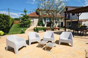 a group of white chairs sitting on a patio at Apartamento Sear Areas in Sanxenxo