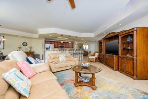 a living room with a couch and a tv at Phoenix on the Bay 1234 condo in Orange Beach