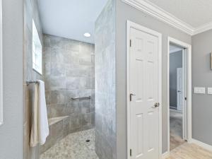 a bathroom with a walk in shower next to a glass door at 5590 Z6 VILLAGE OF FENNEY by REMAX Premier in The Villages