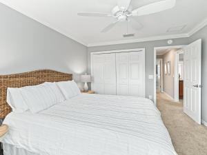 a bedroom with a white bed and a ceiling fan at 5590 Z6 VILLAGE OF FENNEY by REMAX Premier in The Villages +12 photos